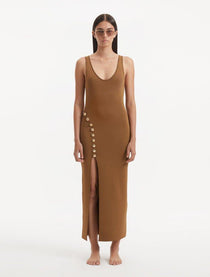 "Model showcasing the Raine Brown Dress from the front, highlighting the elegant scoop neckline, rich brown color, and shimmering shell-shaped gold buttons. "
