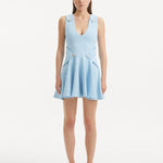 "Model wearing the Rayan Baby Blue Dress from the front, highlighting the finely knitted fabric, serene baby blue color, and shell-shaped gold buttons. "