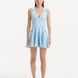 "Model wearing the Rayan Baby Blue Dress from the front, highlighting the finely knitted fabric, serene baby blue color, and shell-shaped gold buttons. "