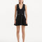 "Model wearing the Rayan Black Dress from the front, highlighting the meticulous knitted fabric, the midnight black color, and the shell-shaped gold buttons. "