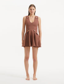 "Model wearing the Rayan Brown Dress from the front, showcasing the premium knitted fabric, the rich brown hue, and the shell-shaped gold buttons."