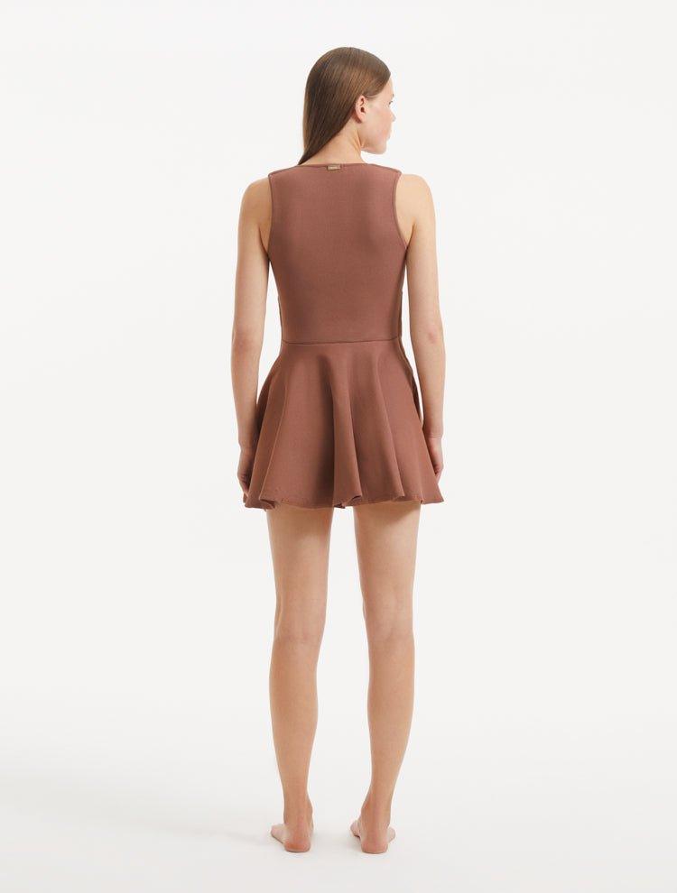 "Model displaying the Rayan Brown Dress from the back, focusing on the smooth knit texture and the thigh-length cut. "