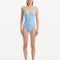 "Model wearing the Reva Baby Blue Swimsuit, showcasing the scoop neckline and underwire feature."