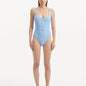 "Model wearing the Reva Baby Blue Swimsuit, showcasing the scoop neckline and underwire feature."