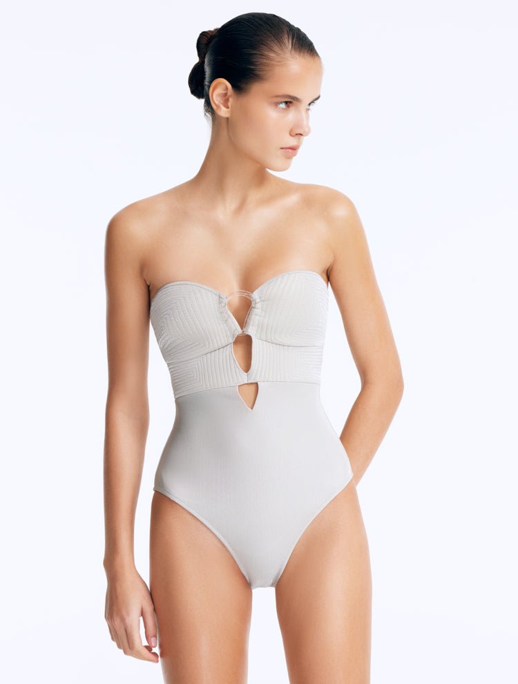 Front View: Model Wearing Rhodes Silver Swimsuit - Strapless Shape, Chic Style, Fully Lined, Metallic Fabric, Clear Glass Accessory, MOEVA Luxury Swimwear