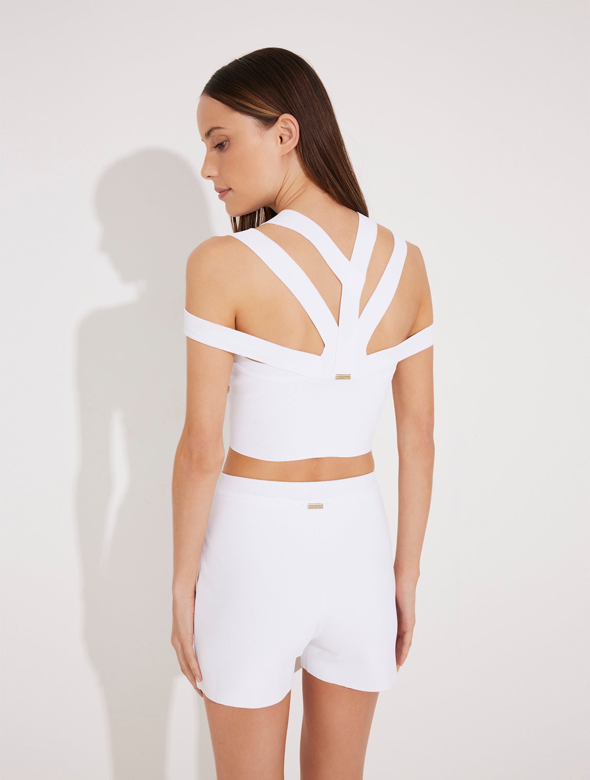 Back View: Model in Rila White Top - Knitted Ready to Wear Cop Top, Multiple Straps , Knitted, Ready to Wear Skirt, MOEVA Luxury Swimwear