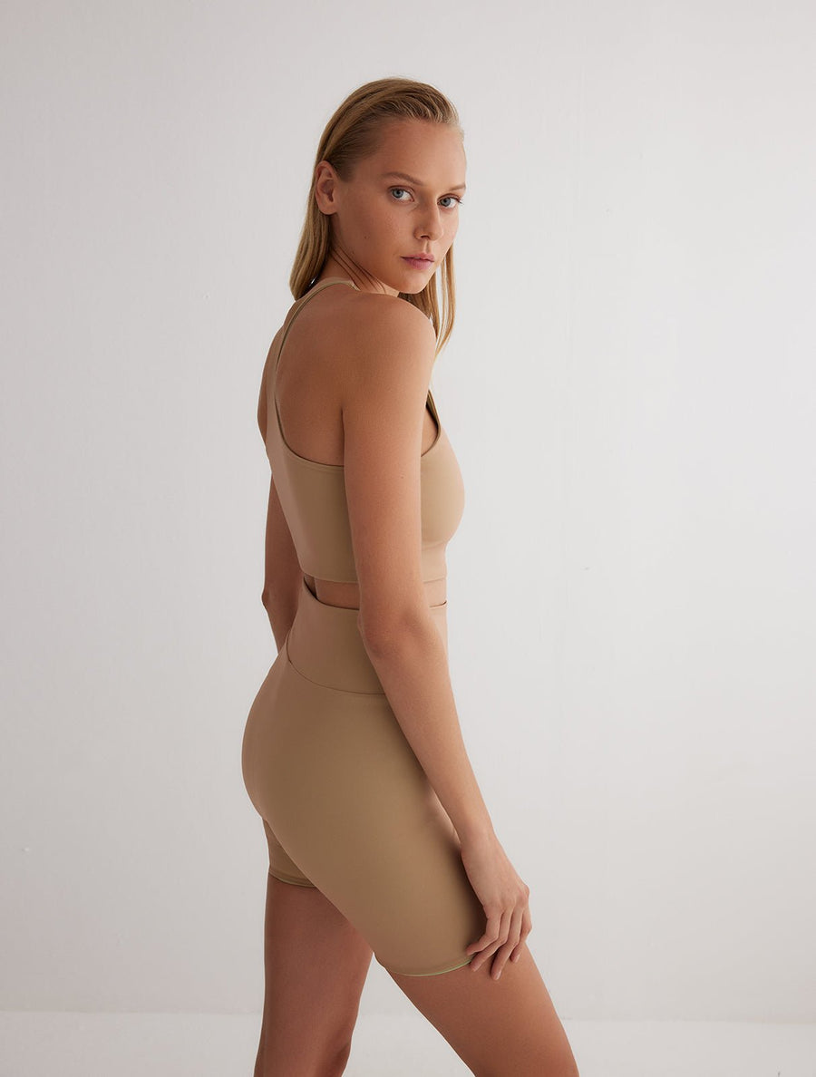 Back View: Model in Rocco Green/Nude Reversible Shorts - MOEVA Luxury Swimwear, 2 in 1 Reversible Short, Suitable for Swimming, 72% Polyamide 28% Elastane, MOEVA Luxury Swimwear