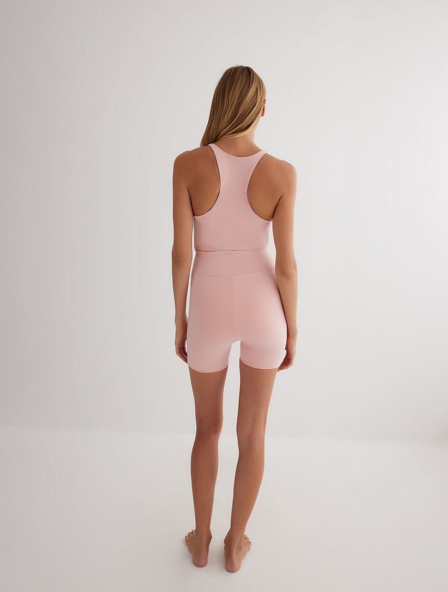 Back View: Model in Rocco Orange/Pink Reversible Shorts - MOEVA Luxury Swimwear, 2 in 1 Reversible Short, Suitable for Swimming, 72% Polyamide 28% Elastane, MOEVA Luxury Swimwear