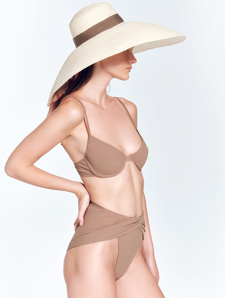 Front View: Model in Romana Nude Hat - Wide Brim, Grosgrain Trim, Moeva Logo Plaque, 100% Toquilla Straw, MOEVA Luxury Swimwear