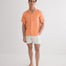 Front View: Model in Romeo Orange Shirt - MOEVA Luxury Swimwear, Spread Collar, Buttoned Cuffs, Button Fastening, Tailored Italian Linen, Short-Sleeved, Regular Fit, Linen, MOEVA Luxury Swimwear