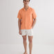 Front View: Model in Romeo Orange Shirt - MOEVA Luxury Swimwear, Spread Collar, Buttoned Cuffs, Button Fastening, Tailored Italian Linen, Short-Sleeved, Regular Fit, Linen, MOEVA Luxury Swimwear