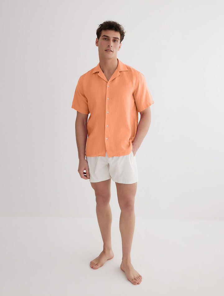 Front View: Model in Romeo Orange Shirt - MOEVA Luxury Swimwear, Spread Collar, Buttoned Cuffs, Button Fastening, Tailored Italian Linen, Short-Sleeved, Regular Fit, Linen, MOEVA Luxury Swimwear