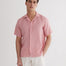 Front View: Model in Romeo Pink Shirt - MOEVA Luxury Swimwear, Spread Collar, Buttoned Cuffs, Button Fastening, Tailored Italian Linen, Short-Sleeved, MOEVA Luxury Swimwear