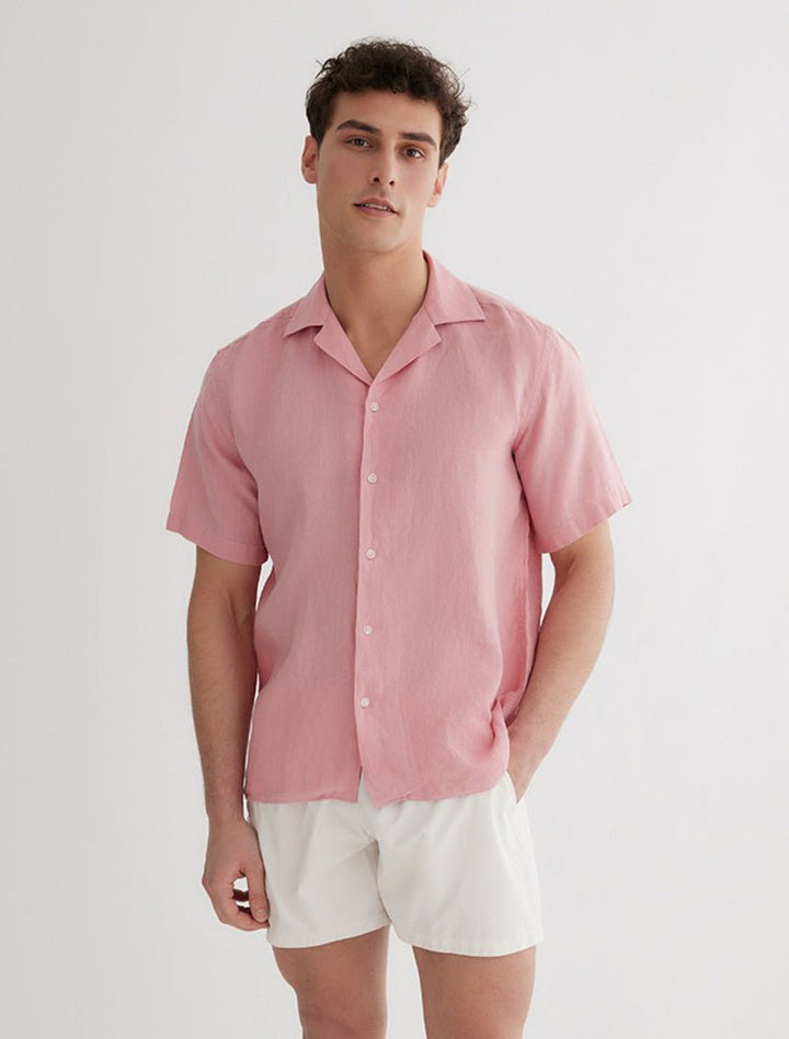 Front View: Model in Romeo Pink Shirt - MOEVA Luxury Swimwear, Spread Collar, Buttoned Cuffs, Button Fastening, Tailored Italian Linen, Short-Sleeved, MOEVA Luxury Swimwear