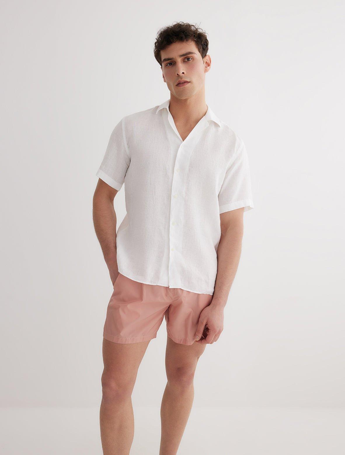 Front View: Model in Romeo White Shirt - MOEVA Luxury Swimwear, Spread Collar, Buttoned Cuffs, Button Fastening, Tailored Italian Linen, Short-Sleeved, MOEVA Luxury Swimwear