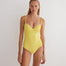 "Model wearing the Ronja Yellow Swimsuit from the front, showcasing the underwired design and ABS chain straps."