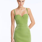 Front View: Model in Rye Green Skirt - Chic Mini Skirt, High Waist, Metallic Fabric, Close Fit, MOEVA Luxury Swimwear