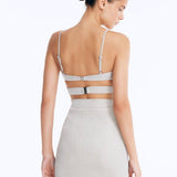 Back View: Rye Silver Skirt on Model - Thigh Length, Topstitching Details, Made of Laminated Swimwear Fabric, MOEVA Luxury Swimwear
