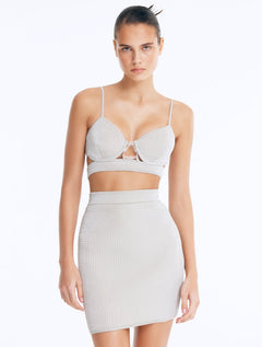 Front View: Model in Rye Silver Skirt - Chic Mini Skirt, High Waist, Metallic Fabric, Close Fit, MOEVA Luxury Swimwear