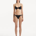 alila Black Bikini Bottom showcasing the sleek low waist design and distinctive wavy texture.