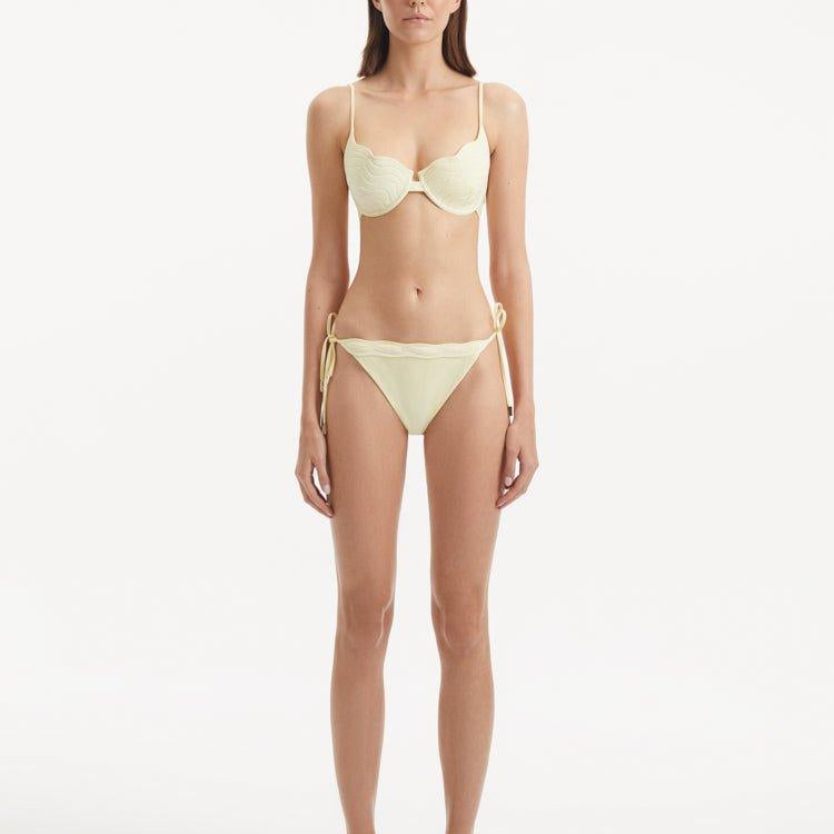 Salila Yellow Side Tie Wave Textured Bikini Bottom | Moeva | Bikini Bottom | Each week unveils new pieces—luxury swimwear, fluid resort silhouettes, and elevated summer-to-evening essentials designed to carry you from coastal escapes to city nights.