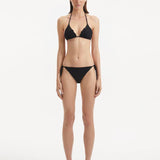 Model wearing the Sarita Black Bikini Set, showcasing the triangle-cut top with refined texture and matching bottoms.