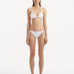 Sarita White Bikini Top featuring its triangle design and wavy texture.