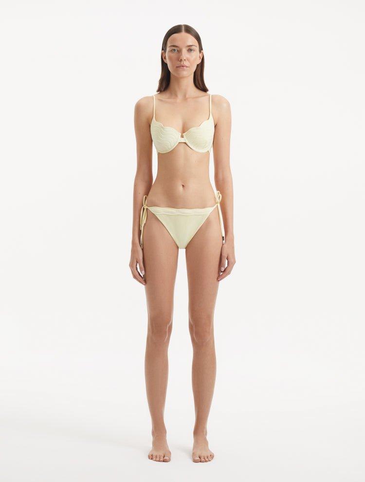 Sarita Yellow Bikini Bottom showcasing its low waist design and unique stitching details.