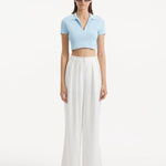 "Model showcasing theShandy Baby Blue Top and Manami White Pants from the front, highlighting the cropped silhouette, elegant V-neckline, and short sleeves. "