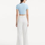 "Model displaying the Shandy Baby Blue Top and Manami White Pants from the back, focusing on the cropped design and clean lines that contribute to the top's chic appearance."