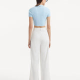 "Model displaying the Shandy Baby Blue Top and Manami White Pants from the back, focusing on the cropped design and clean lines that contribute to the top's chic appearance."