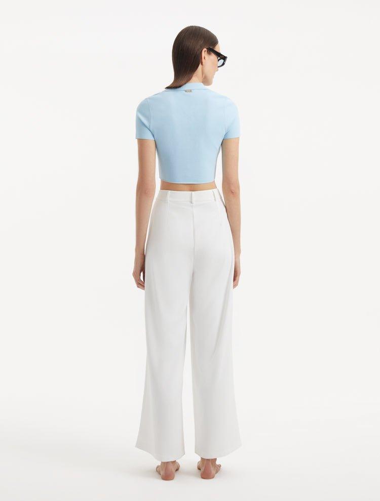 "Model displaying the Shandy Baby Blue Top and Manami White Pants from the back, focusing on the cropped design and clean lines that contribute to the top's chic appearance."