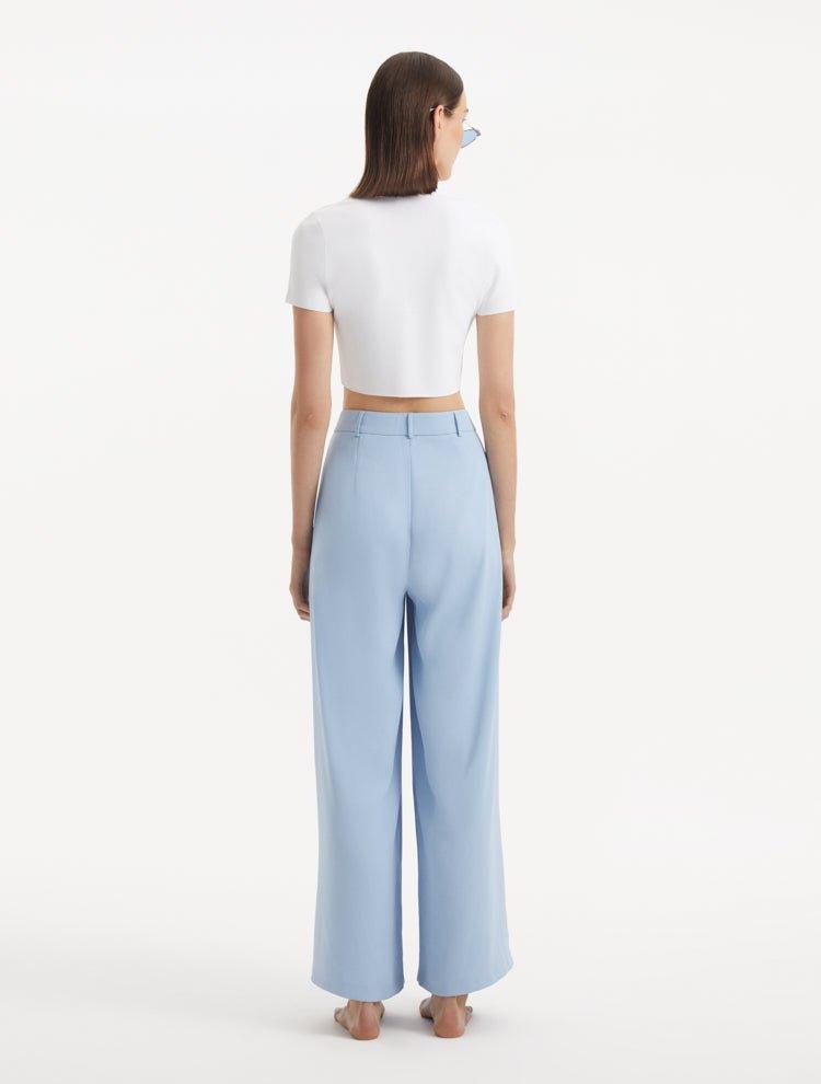 "Model displaying the Shandy White Top from the back, focusing on the cropped cut and the clean, simple lines that enhance the top's sophisticated appearance."