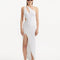 "Model showcasing the Shore White Dress from the front, highlighting its pristine white color, one-shoulder design, and daring slash cut-out detail."
