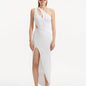 "Model showcasing the Shore White Dress from the front, highlighting its pristine white color, one-shoulder design, and daring slash cut-out detail."