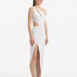 "Model presenting the Shore White Dress from the side, focusing on the enchanting side slit and the ankle-length silhouette. The asymmetric design and ribbed detailing are also featured."