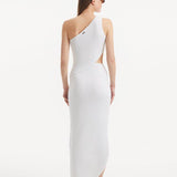 "Model displaying the Shore White Dress from the back, emphasizing the asymmetric one-shoulder design and the elegant side slit that enhances the flowing silhouette."