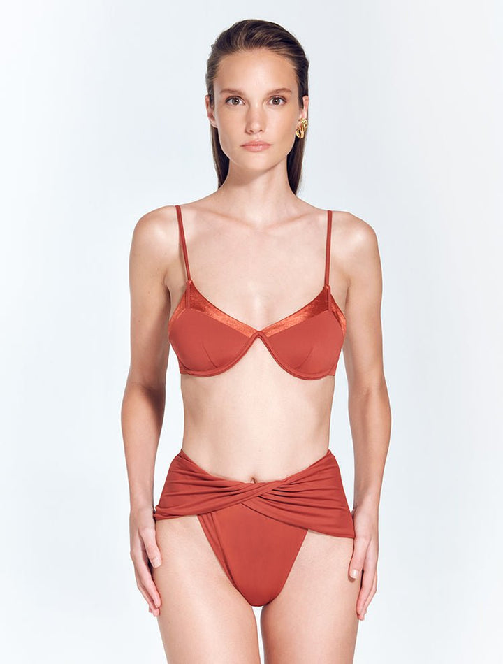 Front View: Model in Skylar Red Ochre Bikini Bottom - MOEVA Luxury Swimwear, High Waist Bikini Bottom, High-Leg Silhouette, Moderate Coverage Bottom, MOEVA Luxury Swimwear