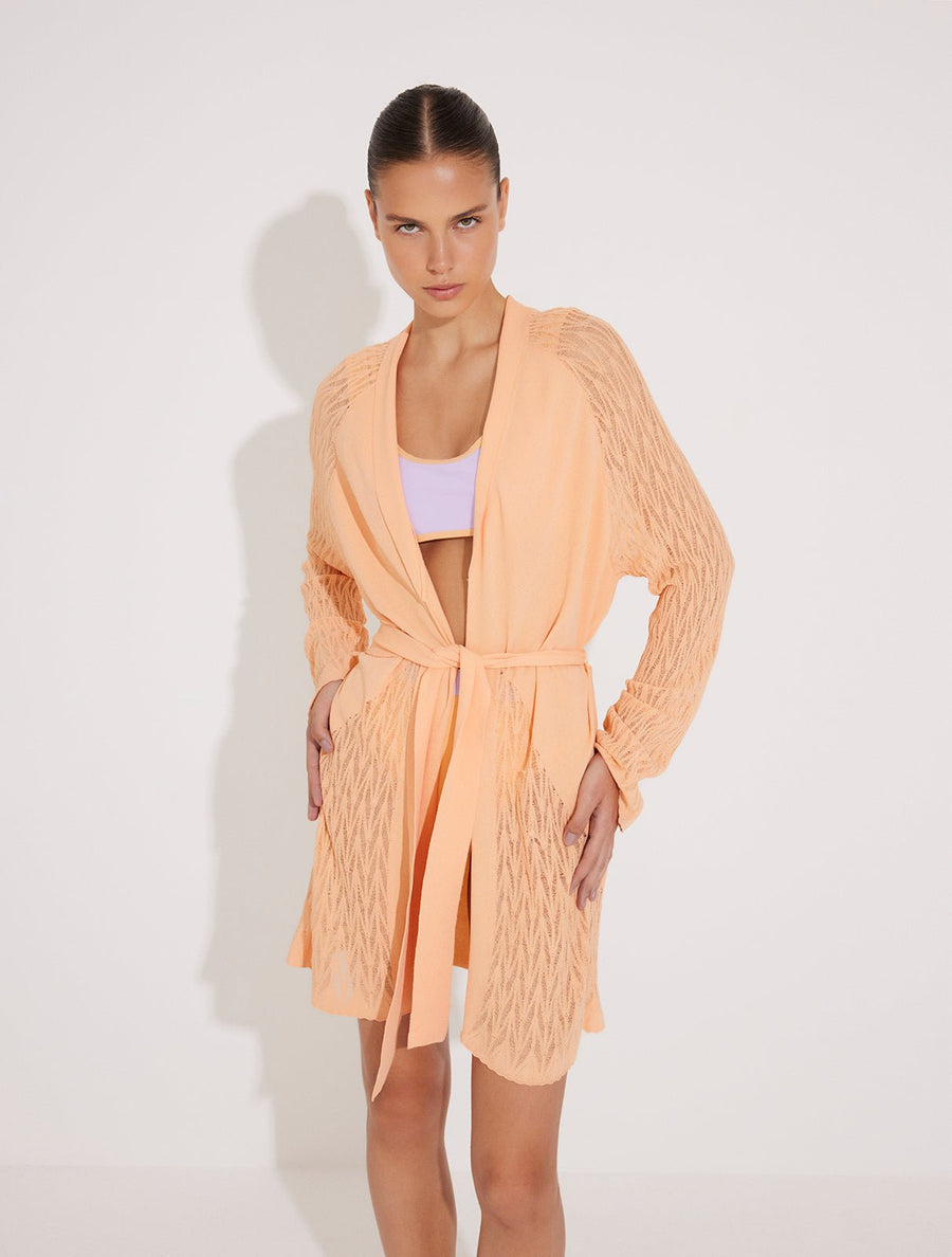 Front View: Model in Tana Orange Kaftan - MOEVA Luxury Swimwear, Mesh Knit, Long-Sleeve, Knee Length, MOEVA Luxury Swimwear