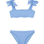 "Front view of the Tia baby blue kids bikini set, showcasing the self-tie straps and ruffle details on the bikini top."