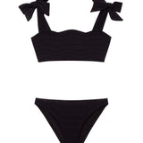 "Front view of the Tia black kids bikini set, highlighting the ruffle details on the bikini top."