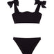 "Front view of the Tia black kids bikini set, highlighting the ruffle details on the bikini top."