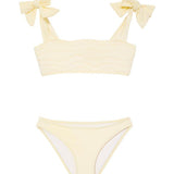 "Front view of the Tia yellow kids bikini set, showing the self-tie top with ruffle details and full-coverage bottoms."