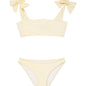 "Front view of the Tia yellow kids bikini set, showing the self-tie top with ruffle details and full-coverage bottoms."