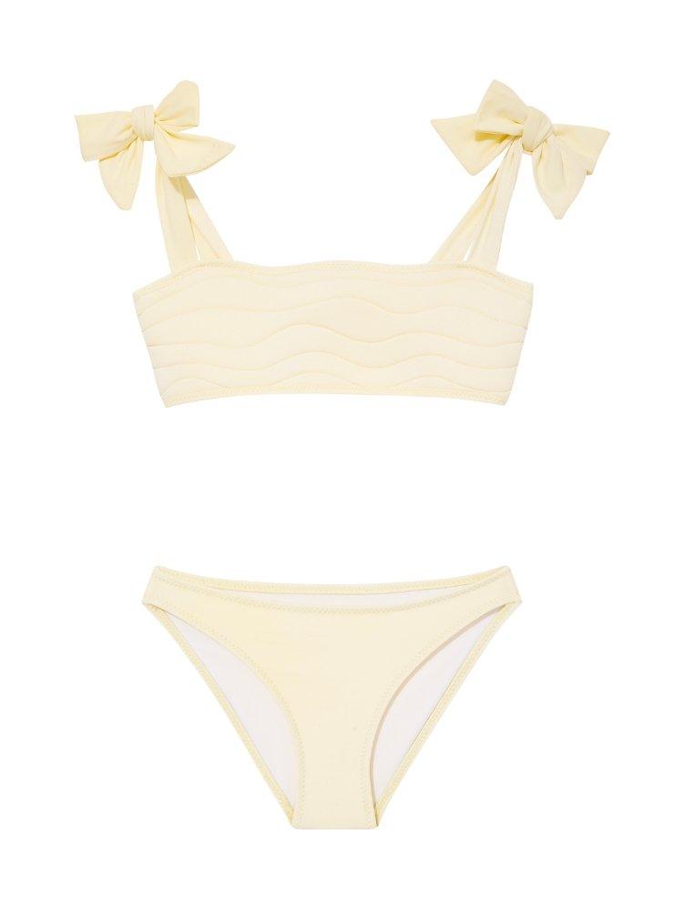 "Front view of the Tia yellow kids bikini set, showing the self-tie top with ruffle details and full-coverage bottoms."