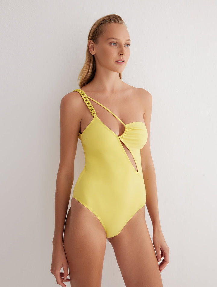 Front View: Model in Tindra Yellow Swimsuit - MOEVA Luxury Swimwear, One Shouldered, ABS Chain Straps, Ruched Detail in the Top, MOEVA Luxury Swimwear