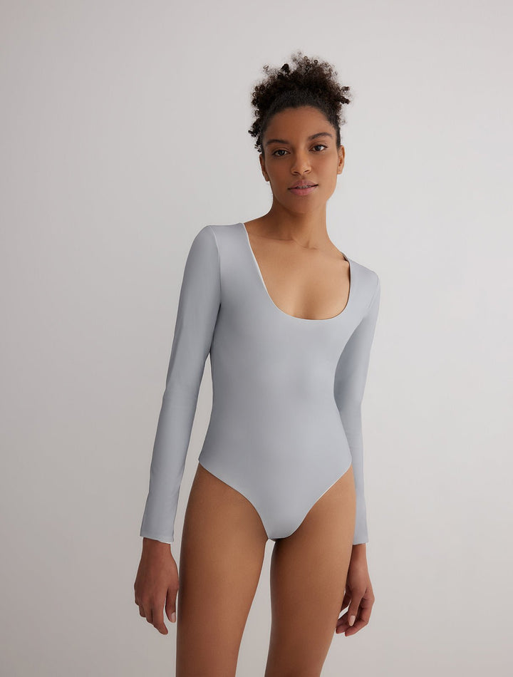 Front View: Model in Ulrika Grey/White Reversible Bodysuit - MOEVA Luxury Swimwear, 2 in 1 Reversible Bodysuit, Suitable for Swimming, Scoop Neckline, MOEVA Luxury Swimwear