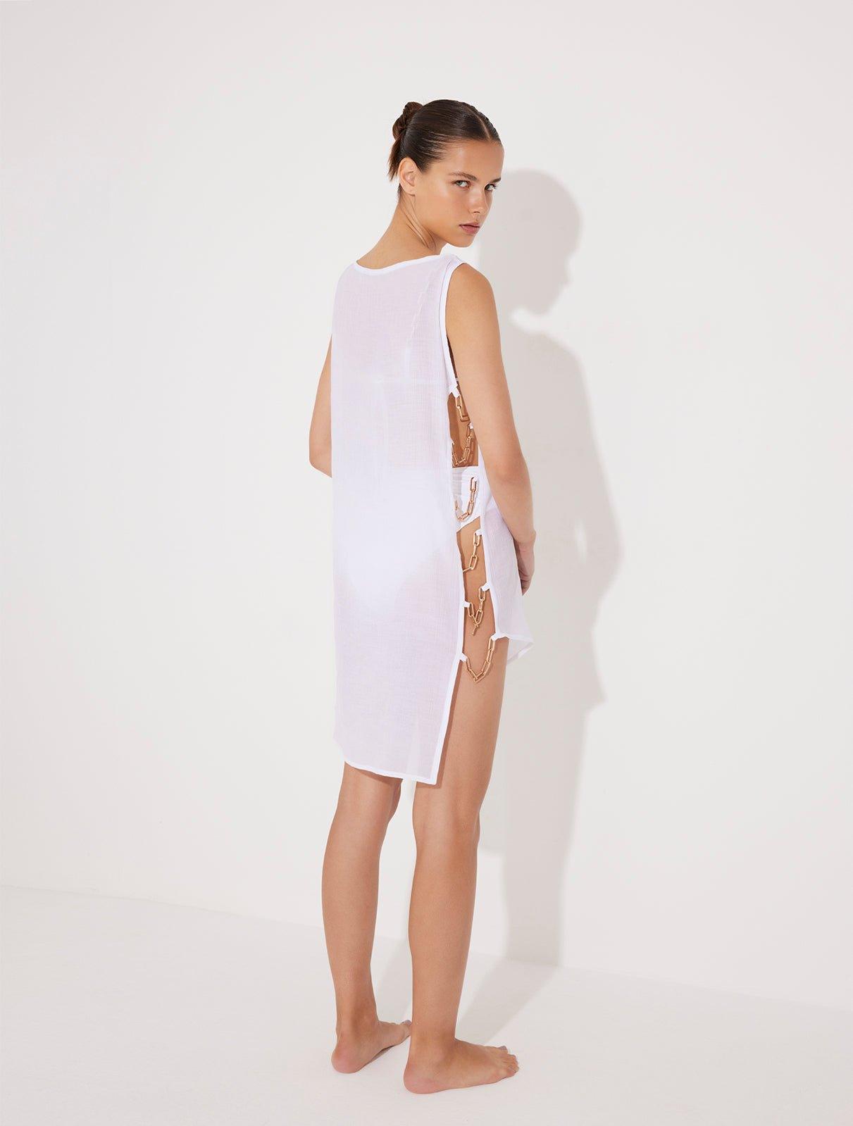 Veronica White Sheer Mini Dress with Side Chain Detail | Moeva | Beachwear Dresses | Each week unveils new pieces—luxury swimwear, fluid resort silhouettes, and elevated summer-to-evening essentials designed to carry you from coastal escapes to city nights.