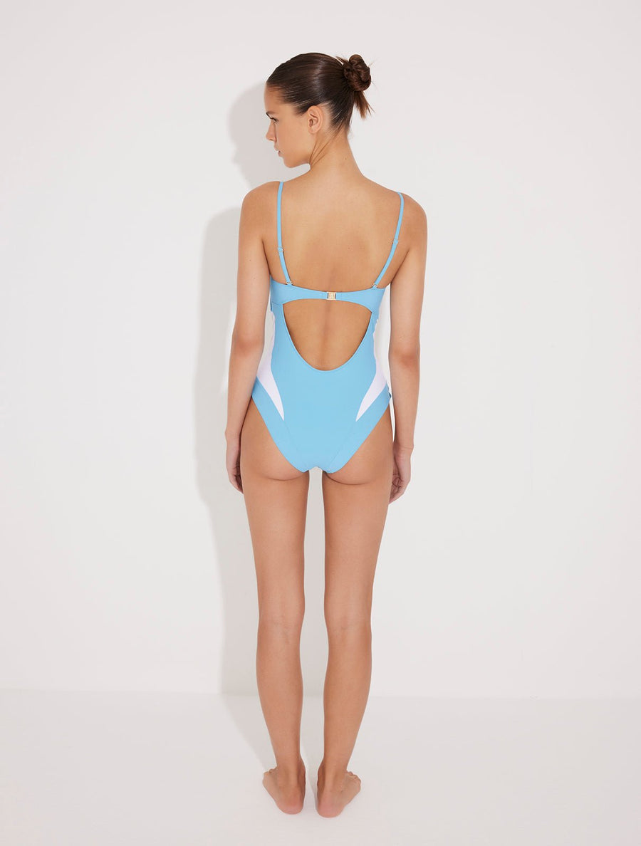 Back View: Model in Vivia Blue/White Swimsuit - MOEVA Luxury Swimwear, Gold Clasps at the Back, Full Bottom Coverage, Fully Lined, Removable Adjustable Straps, Italian Fabric, MOEVA Luxury Swimwear
