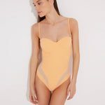 "Model wearing the Vivia Orange/Nude Molded Cup Strapless Swimsuit from the front, showcasing the geometric embroidery that contours the figure and the molded cups that offer support and a push-up effect. "
